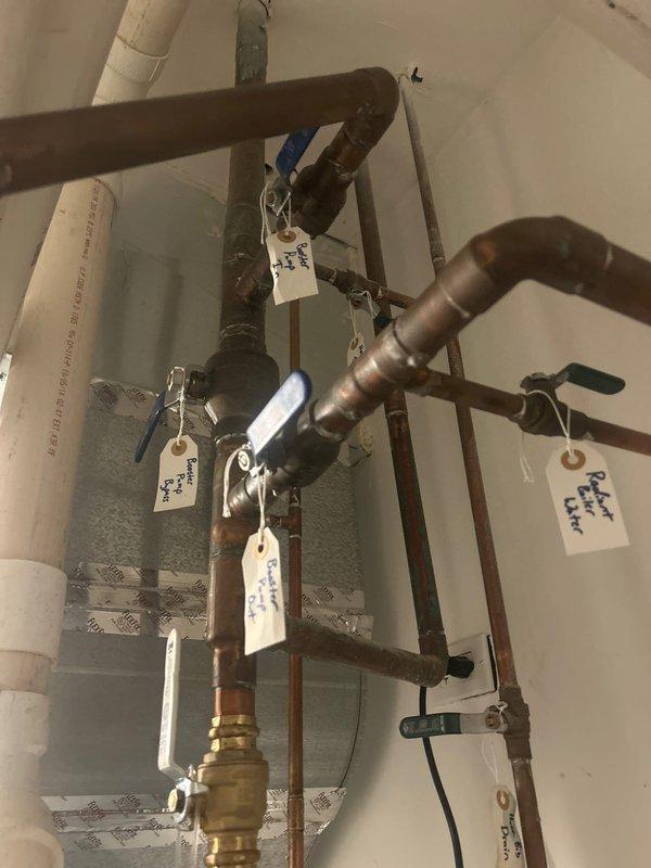 Responded to service call for reported broken water pump affecting residential property. Upon arrival, accessed property using provided lockbox and conducted thorough inspection of the plumbing system. Evaluated the booster pump assembly and associated copper piping network, including multiple ball valves, brass fittings, and distribution lines serving the domestic water system. Examined the pump installation mounted alongside water heater and related plumbing infrastructure. Documented existing conditions through photographs showing the complete piping configuration with various zones and circuits. Assessed all connections, valves, and fittings for proper operation and identified issues affecting water pressure delivery throughout the home. Maintained communication with homeowner throughout the service visit to provide updates and recommendations for resolving the water pump malfunction.