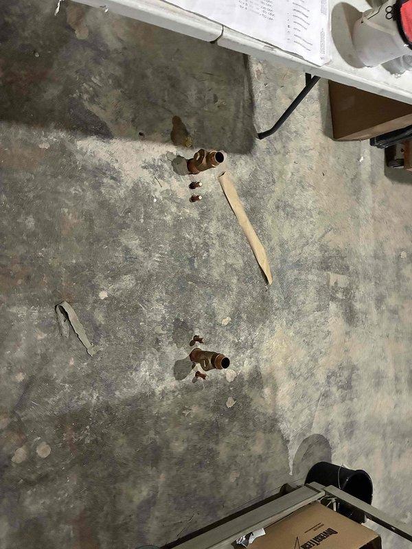 Completed installation of copper piping system in commercial space with exposed ceiling infrastructure. Installed vertical pipe runs with proper valve fittings and integrated new plumbing lines with existing mechanical systems including ductwork and electrical conduits. Parts were provided for the installation, and comprehensive documentation photos were captured showing the completed work in the exposed ceiling area and floor-level valve installations.