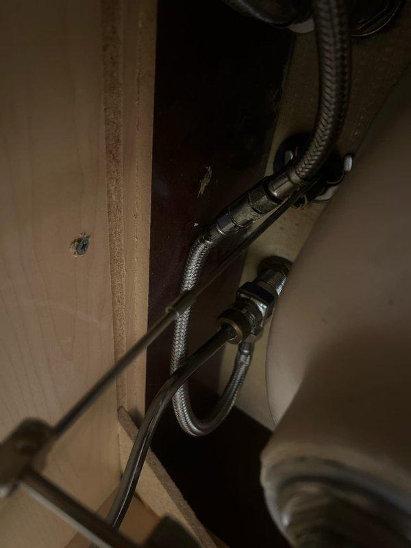 Responded to service call for bathroom faucet installation. Upon inspection, identified that a three-handle widespread chrome faucet set required installation on an undermount sink with marble countertop. Customer did not have necessary parts or components available at time of visit. Documented existing plumbing configuration including flexible braided supply lines and connection points beneath vanity. Photographed current setup showing faucet placement, drain assembly with chrome pop-up stopper, and under-sink plumbing infrastructure for reference upon return. Scheduled follow-up appointment to complete installation once customer obtains required parts.