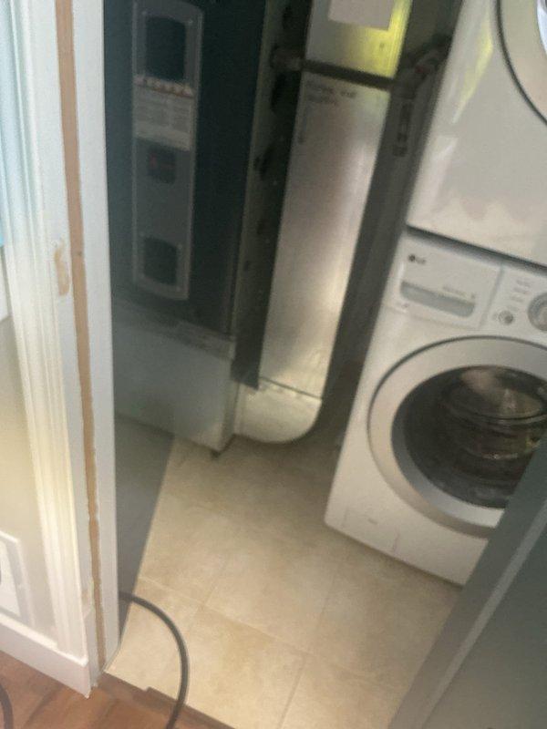 Responded to rescheduled priority call back at multi-unit residential property. Conducted site inspection of utility room containing washing machine and HVAC equipment, documented conditions with photos for service records. No immediate plumbing repairs were required during this follow-up visit.