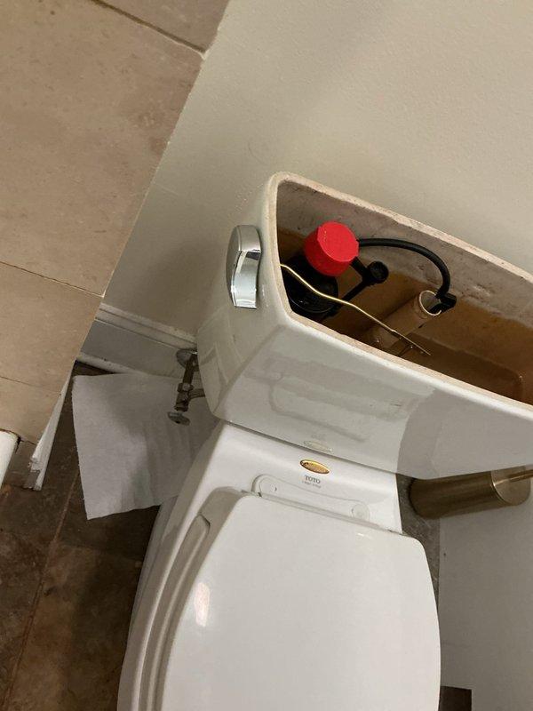 Responded to service call for toilet leaking at wall connection. Upon inspection, identified water seepage from the tank-to-bowl mounting area. Removed tank lid to assess internal components and check for additional issues contributing to the leak. Inspected fill valve, flapper assembly, and tank bolts for wear or deterioration. Determined leak originated from compromised tank-to-bowl gasket and loose mounting hardware. Tightened tank bolts to manufacturer specifications and verified proper seal. Tested flush mechanism multiple times to confirm leak was resolved and no water was escaping at connection points. System restored to proper working condition.