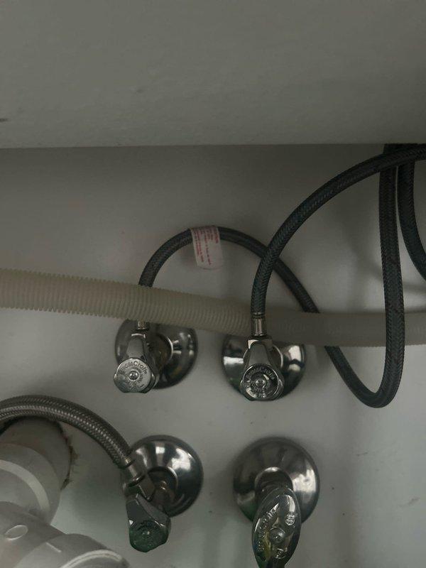 Conducted on-site assessment for whole-house water filtration system installation. Evaluated existing plumbing infrastructure including under-sink configuration with copper supply lines, PVC drainage system, and current shut-off valve locations. Documented cabinet space dimensions and plumbing access points to determine optimal placement for filtration equipment. Photographed existing water supply connections, valve assemblies, and available mounting locations to develop comprehensive installation plan for point-of-entry water treatment system.