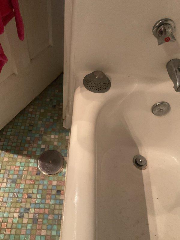 Responded to a clogged drain emergency at a 126-year-old residential condo where water was backing up through the trap and threatening to leak to the unit below. Upon arrival, assessed the bathroom plumbing system and identified the blockage affecting both the bathtub and sink drains. Successfully cleared the stoppage, restored proper drainage function, and verified water flow through the system. Advised the occupant that fixtures were safe to use and documented the completed work with photographs.