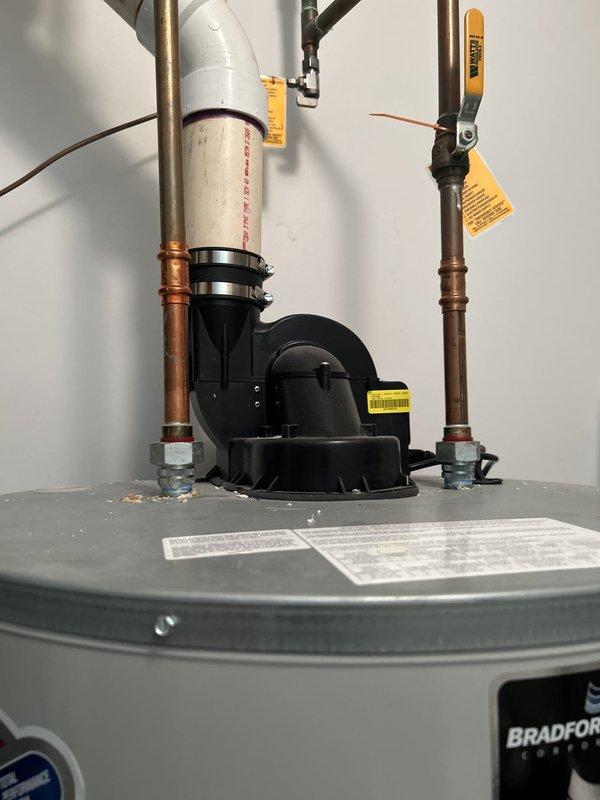 Responded to a clogged toilet call at a 22-year-old single-family residential property. Upon arrival, assessed the fixture and successfully cleared the blockage using standard plumbing techniques. Documented the installation with photographs showing the overall plumbing system configuration, including the water heater setup and utility area conditions, to provide a complete record of the service visit.