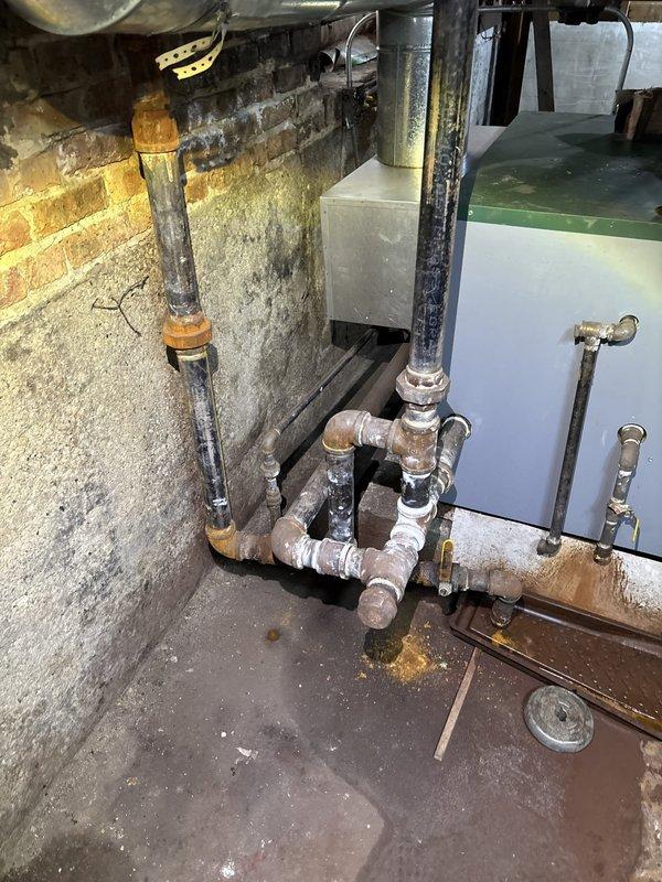 Responded to emergency call for leaking heating pipes in basement mechanical room. Upon inspection, identified corroded threaded pipe fittings and couplings on the heating system manifold with active water seepage at multiple connection points. Replaced deteriorated galvanized steel pipe sections and fittings, installed new threaded couplings, and pressure-tested all connections to ensure proper seal and system integrity. All leaks resolved and heating system restored to full operational status.