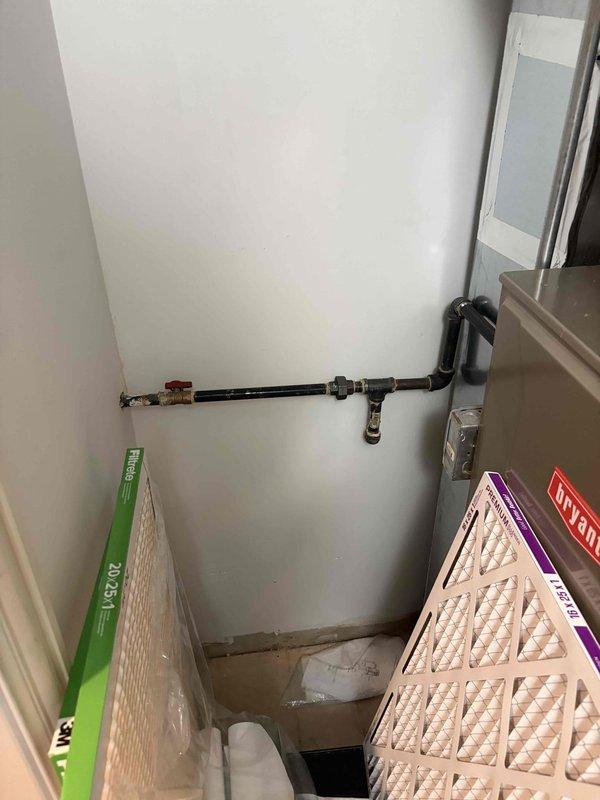 Conducted on-site assessment for conversion from dual electric tankless water heaters to single gas tankless unit in 15-year-old residential property. Evaluated existing electrical infrastructure including conduit and meter box mounted on exterior brick wall, documented current mechanical closet configuration housing HVAC equipment and utility access points. Provided comprehensive estimate for gas line installation, venting requirements, electrical modifications, and removal of existing electric tankless systems to facilitate upgrade to gas-fired tankless water heater system.