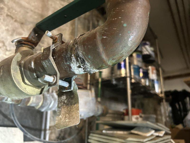 Responded to basement water leak investigation. Located active leak on insulated copper piping system showing significant moisture accumulation and condensation on foam pipe insulation. Identified compromised pipe sections with visible corrosion, oxidation, and patina on copper fittings and connections. Documented aged plumbing infrastructure including corroded elbow joints, deteriorated metal clamps, and threaded valve connections displaying environmental wear. Photographed affected areas showing water droplets and wet patches on insulation material. Provided estimate for necessary repairs to address leak source and damaged components.
