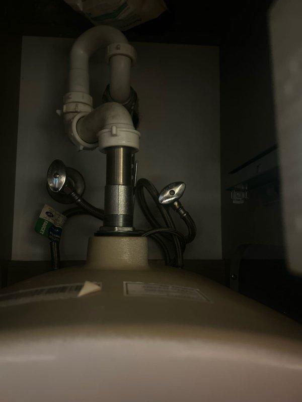 Responded to low water pressure complaint in 50-year-old residential property. Conducted comprehensive system evaluation including inspection of fixtures, supply lines, and pressure at multiple points throughout the home. Inspected bathroom shower system with dual rainfall and handheld showerhead configuration, tested flow rates and checked for potential blockages or restrictions in fixtures. Examined under-sink plumbing including P-trap assembly and garbage disposal connections for signs of corrosion, sediment buildup, or partial obstructions that could contribute to reduced pressure. Assessed age-related issues common in older plumbing systems including potential galvanized pipe deterioration and mineral accumulation in supply lines.