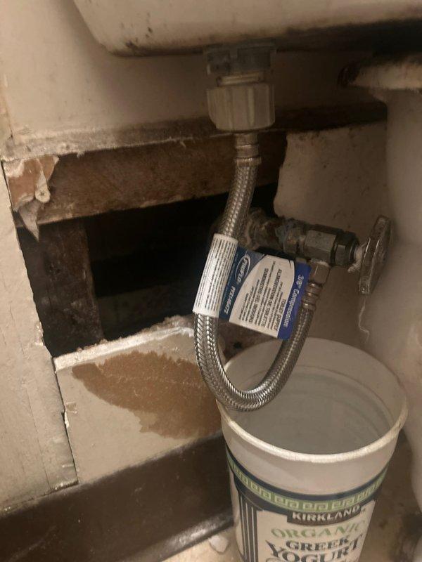 Replaced deteriorated 1/2" galvanized water supply line serving first floor bathroom fixture with new copper piping. Shut off water at isolation valve, drained cold side plumbing, and expanded existing drywall access opening to facilitate proper removal of corroded galvanized pipe and secure installation of copper line. Installed new 1/2" x 3/8" angle stop with braided stainless steel supply line and verified system functionality through pressure testing. All work includes one-year parts and pipework warranty.