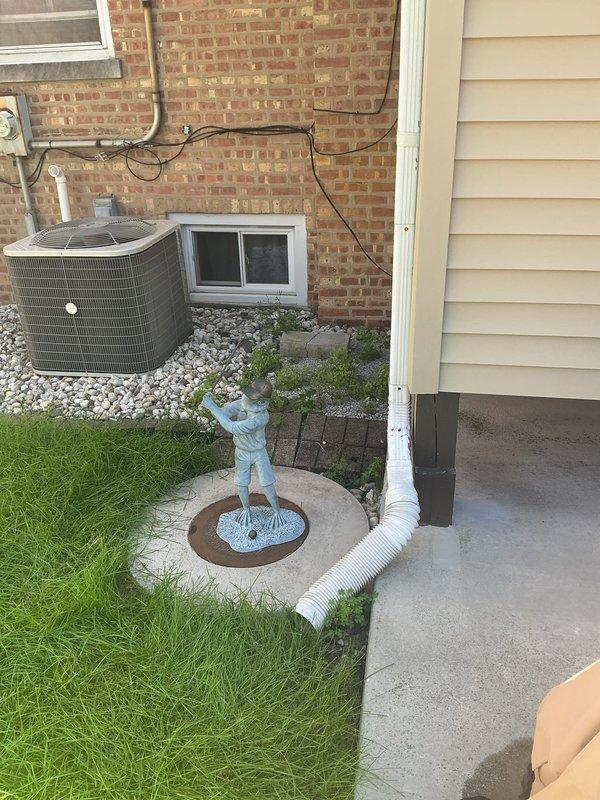 Completed residential drain and sewer estimate for a property with a deteriorating pipe leading to the catch basin and basement remodeling requirements. Assessed the existing plumbing configuration in the basement utility area, including water heater and HVAC system locations, to determine optimal routing for sewer lines that need to be reconfigured during the renovation. Evaluated exterior drainage conditions around the foundation, noting the presence of existing downspout systems, landscaping features, and HVAC equipment placement that may impact excavation and pipe installation access points for the collapsing catch basin line repair.