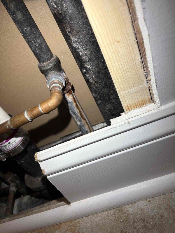 Responded to service call for bathroom sink water line repair. Upon inspection, accessed plumbing infrastructure through wall cavity near floor level to locate the source of the leak. Identified compromised connection point between copper supply line and black pipe section serving the bathroom sink. Repaired the defective threaded fitting and connection to restore proper water flow to the fixture. Verified all connections were secure and tested system for leaks before closing access point.