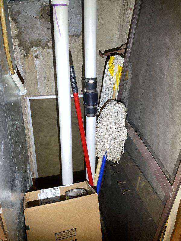 Completed waste pump installation in basement utility area with new PVC discharge piping and mounting hardware. Assessed existing backup system components including inverter and battery condition for planned replacement work. Verified proper drainage access point and confirmed structural conditions for pump operation in moisture-prone environment.