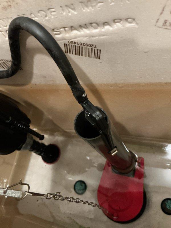 Responded to callback for toilet malfunction following previous repair attempt. Upon inspection, identified improperly installed flush valve assembly with misaligned flapper chain causing incomplete seal and continuous running. Adjusted chain length to manufacturer specifications, ensuring proper flapper operation and complete closure. Tested flush mechanism multiple times to verify reliable operation and proper tank refill. Inspected fill valve and supply line connections for leaks or damage; all connections secure with no visible water leakage. Toilet now functioning correctly with full flush cycle and proper water shutoff.