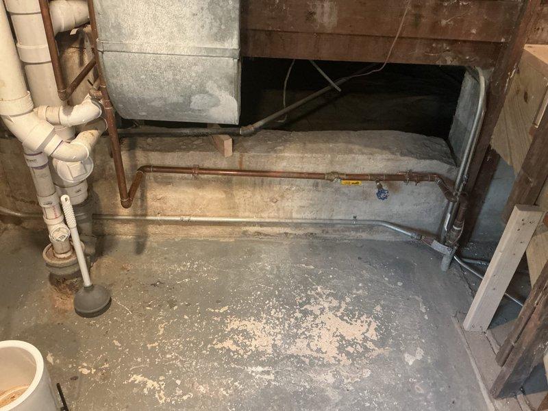 Responded to service call for main line leak repair in residential property. Upon inspection, identified moisture damage and staining on basement concrete floor indicating active leak in main sewer line. Assessed existing plumbing infrastructure including PVC drainage system, aged copper supply lines, and galvanized components showing signs of deterioration. Performed necessary main line repairs to resolve leak issue and restore proper drainage function. Additionally, installed customer-supplied shut off valve on toilet supply line, connecting flexible braided supply line from chrome angle stop valve to toilet tank with proper compression fittings to ensure leak-free operation. Tested all repairs for proper function and verified no active leaks present upon completion.