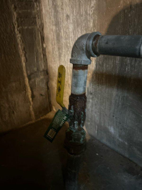Completed comprehensive plumbing repair addressing multiple critical water system failures in a multi-unit building. Utilized pipe freezing technology to isolate and replace a leaking 1" galvanized main shut-off valve without disrupting water service to eight adjacent units. Cut into the existing galvanized line, removed the failed valve, and installed a new 1" IP ball valve with approximately 3 feet of new pipework. Thawed the line and verified proper operation under full pressure.

Replaced a failed hose bib shut-off valve and exterior spigot assembly. Shut down the building's water supply, drained the system, and cut into the deteriorated 3/4" galvanized line. Removed the defective valve with broken handle and the leaking hose bib. Installed a new 3/4" shut-off valve and exterior spigot, restored water pressure, and tested all connections for leaks and proper functionality.

All work performed on aging galvanized water lines showing significant corrosion and deterioration. System pr