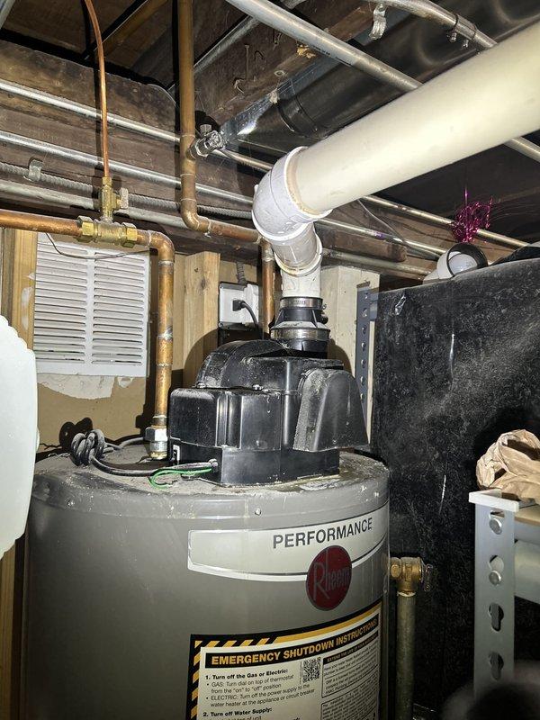 Responded to no hot water complaint at residential property. Upon arrival, inspected Performance brand tanked water heater located in basement utility area. Verified complete loss of hot water throughout home. Conducted diagnostic assessment of water heater unit, examining control assembly, thermostat operation, and heating elements. Evaluated electrical connections and power supply to unit. Inspected emergency shutdown system and safety controls on equipment. Checked gas supply lines, valves, and connections for proper operation. Assessed overall condition of water heater including tank integrity, temperature and pressure relief valve, and venting system. Examined surrounding plumbing infrastructure including copper supply lines and associated piping. Documented equipment specifications and current operating conditions. Photographed installation for service records showing water heater configuration, piping layout, and mechanical systems. Identified error condition preventing proper h
