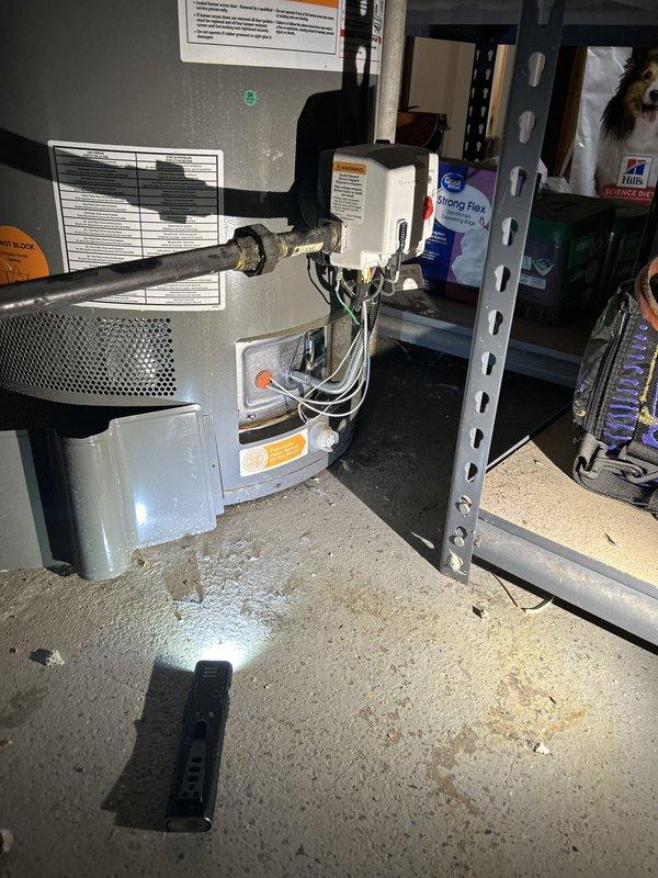 Responded to no hot water complaint at residential property. Upon arrival, inspected Performance brand tanked water heater located in basement utility area. Verified complete loss of hot water throughout home. Conducted diagnostic assessment of water heater unit, examining control assembly, thermostat operation, and heating elements. Evaluated electrical connections and power supply to unit. Inspected emergency shutdown system and safety controls on equipment. Checked gas supply lines, valves, and connections for proper operation. Assessed overall condition of water heater including tank integrity, temperature and pressure relief valve, and venting system. Examined surrounding plumbing infrastructure including copper supply lines and associated piping. Documented equipment specifications and current operating conditions. Photographed installation for service records showing water heater configuration, piping layout, and mechanical systems. Identified error condition preventing proper h