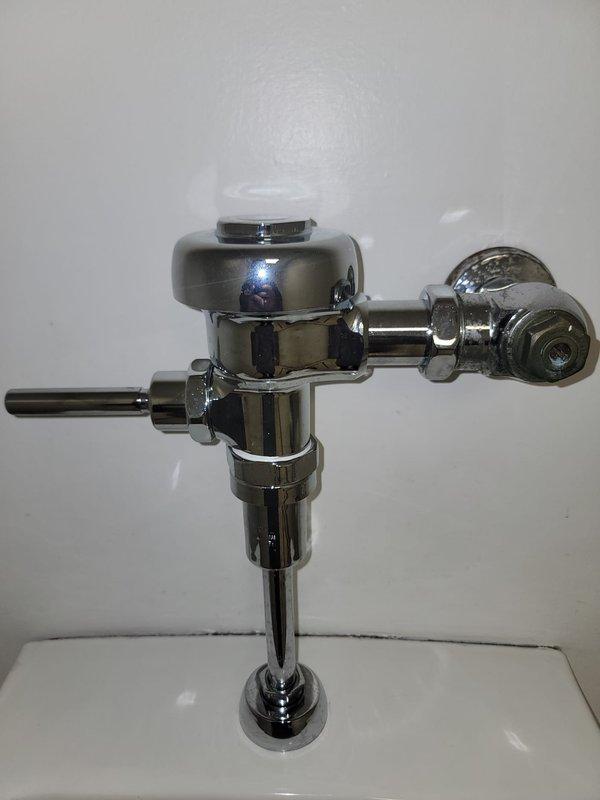 Responded to a commercial men's restroom for a continuously running urinal. Upon arrival, confirmed the isolation valve had been closed by facility staff to stop water flow. Inspected the wall-mounted urinal and chrome flush valve assembly. Diagnosed faulty flushometer diaphragm causing constant water discharge. Replaced diaphragm kit, reassembled flush valve mechanism, restored water supply, and tested operation. Verified proper flush cycle and complete water shutoff. Unit now functioning normally with no leaks detected.
