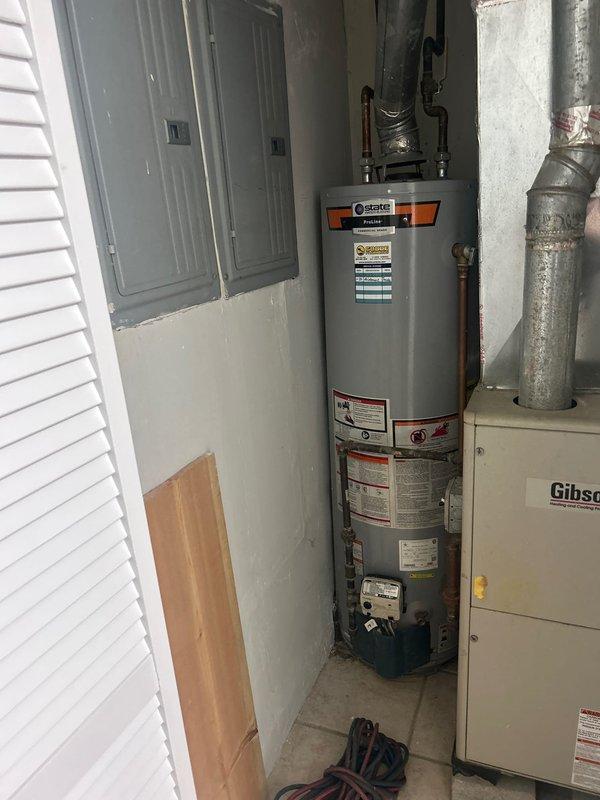 Responded to no hot water complaint and assessed failed tank water heater originally installed in 2021. Documented existing State brand water heater installation with measurements and photographed current condition of unit, including all connections, piping configuration, and mechanical room layout for estimate preparation.
