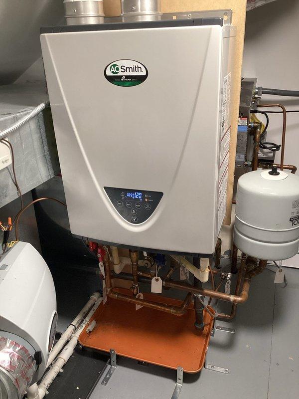 Performed maintenance service on AO Smith tankless water heater experiencing intermittent operation with error code display. Diagnosed faulty air fuel sensor causing unit to cycle on and off. Inspected internal control panel, electrical connections, and sensor assembly. Documented existing copper piping configuration, expansion tank, safety valves, and drip pan installation. Provided assessment that air fuel sensor requires replacement to restore proper unit operation and resolve error code condition.