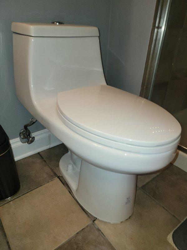 Responded to a service call for a leaking toilet caused by a failed wax ring seal. Removed and reset the toilet fixture, replaced the deteriorated wax seal with a new one, reinstalled the unit with proper bolting and alignment, and tested for leaks to ensure a watertight seal at the floor flange connection.