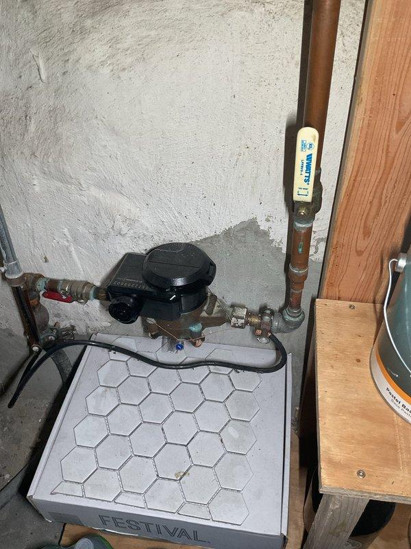 Performed camera inspection of residential plumbing system including water heater installation area and utility connections. Documented existing plumbing infrastructure including Rheem Performance Platinum tankless water heater, sump pump assembly, copper supply lines, PVC drainage system, and associated valves and fittings for diagnostic purposes.