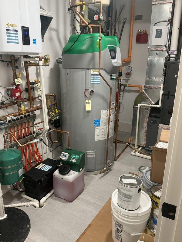 Completed comprehensive VIP plumbing maintenance on a newer residential system in a home built in 2023-2024. Inspected and serviced water heater with copper piping connections, wall-mounted boiler system with manifold distribution, expansion tank, circulation pump, and associated plumbing components including PVC drainage lines and AquaNot battery backup system. All equipment found operating within normal parameters with no deficiencies noted during inspection.