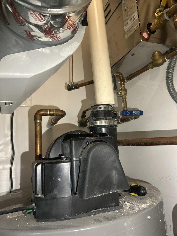 Responded to service call for disconnected PVC pipe and unusual noise from 7-year-old tanked water heater. Upon inspection, identified loose condensate drain line connection at water heater base causing intermittent rattling sound. Reconnected and secured PVC condensate drain piping with proper fittings and support. Verified all plumbing connections at water heater including inlet/outlet copper lines, pressure relief valve discharge pipe, and expansion tank connections were secure and functioning properly. Tested water heater operation and confirmed elimination of noise issue with condensate system properly draining.