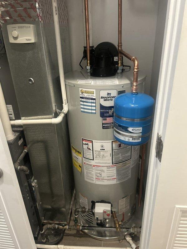 Responded to service call for disconnected PVC pipe and unusual noise from 7-year-old tanked water heater. Upon inspection, identified loose condensate drain line connection at water heater base causing intermittent rattling sound. Reconnected and secured PVC condensate drain piping with proper fittings and support. Verified all plumbing connections at water heater including inlet/outlet copper lines, pressure relief valve discharge pipe, and expansion tank connections were secure and functioning properly. Tested water heater operation and confirmed elimination of noise issue with condensate system properly draining.