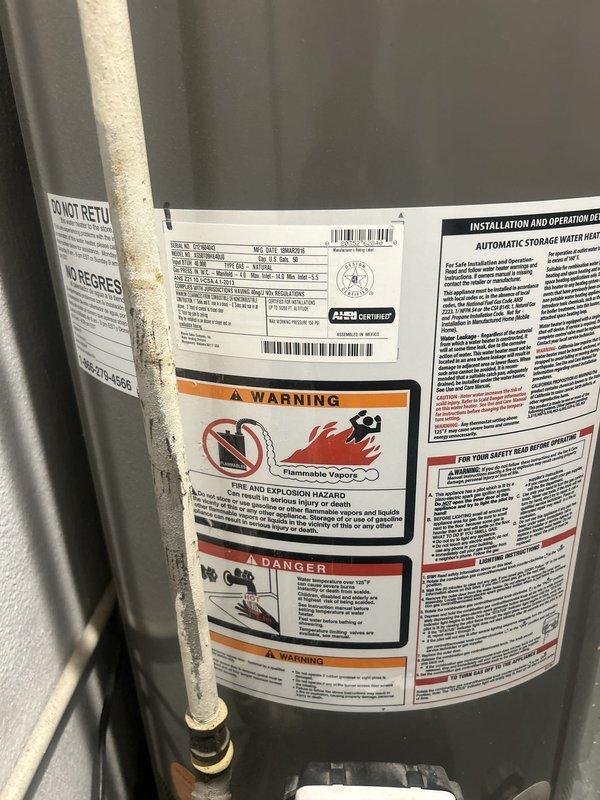 Responded to service call for clogged floor drain and water heater inspection. Upon arrival, assessed the floor drain condition and performed diagnostic evaluation of the water heater system. Inspection revealed significant mineral scale and crystalline buildup accumulation on copper piping connections, indicating long-term hard water deposits affecting water flow and system efficiency. Documented water heater unit specifications, safety labels, and current operational status with detailed photographic evidence. Provided assessment findings and recommendations for addressing mineral buildup issues and ensuring proper drainage system function.