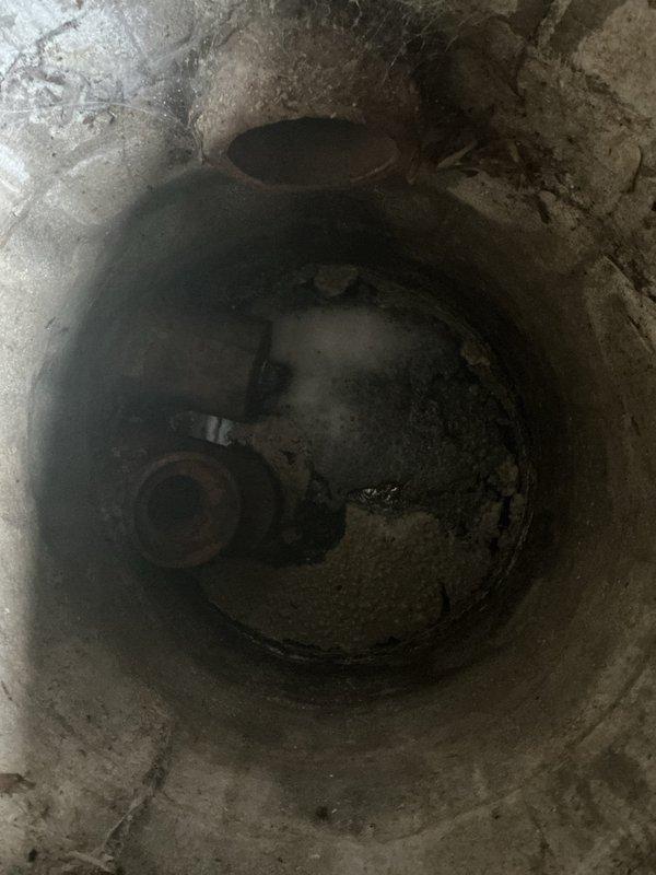 Conducted a comprehensive site assessment to update previously provided drainage and sewer estimates from July. Inspection included evaluation of the existing sump pump system located in a concrete pit showing signs of moisture exposure and age-related deterioration, as well as examination of exterior drainage conditions beneath the deck area where pavers displayed biological growth and moisture accumulation near the HVAC condenser unit. Documented current conditions through photographic evidence to support revised estimate recommendations for necessary drainage and sewer system improvements.