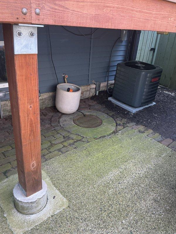 Conducted a comprehensive site assessment to update previously provided drainage and sewer estimates from July. Inspection included evaluation of the existing sump pump system located in a concrete pit showing signs of moisture exposure and age-related deterioration, as well as examination of exterior drainage conditions beneath the deck area where pavers displayed biological growth and moisture accumulation near the HVAC condenser unit. Documented current conditions through photographic evidence to support revised estimate recommendations for necessary drainage and sewer system improvements.