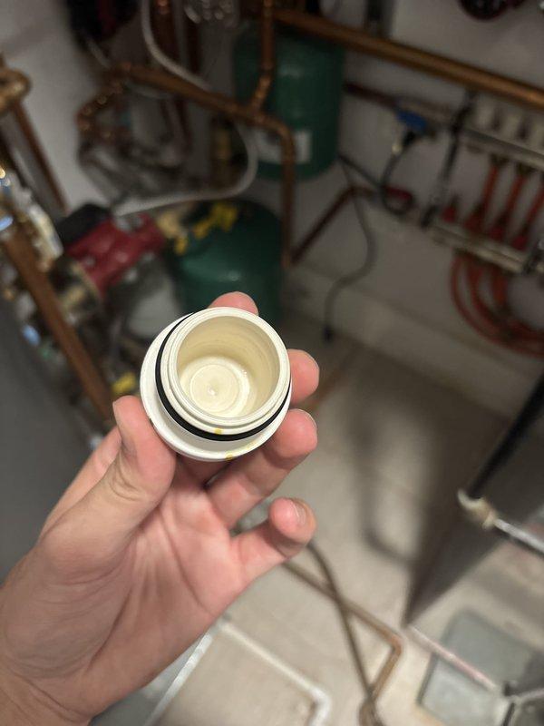 Responded to service call for recently installed boiler displaying error code. Upon arrival, inspected boiler system and identified clogged inlet filter as source of malfunction. Removed and cleaned white plastic strainer component with fine mesh screen from water supply line. Filter showed debris accumulation restricting water flow, which triggered low water pressure error on boiler control board. Flushed filter housing, reinstalled clean filter with gasket properly seated, and restored water supply to unit. Cleared error code from boiler system, verified proper operation, and confirmed adequate water flow through all connections. System tested and returned to normal operating parameters.