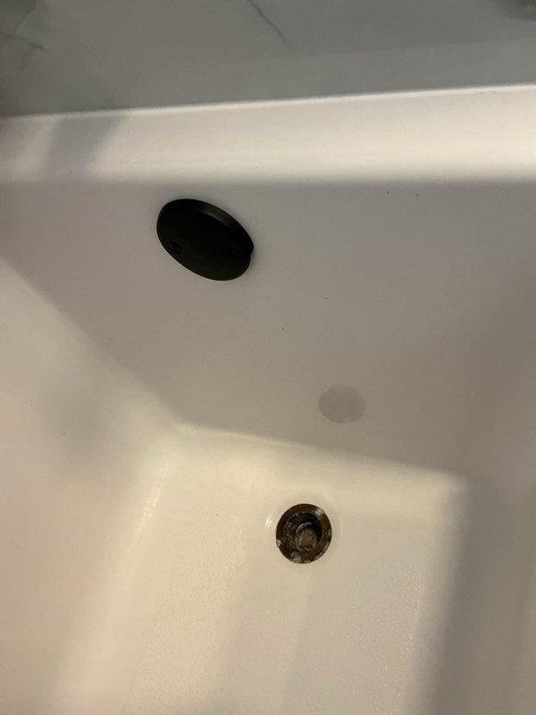 Responded to service call for bathtub drain replacement. Removed existing deteriorated drain assembly showing significant tarnishing and discoloration. Installed new drain kit with chrome finish, including updated gaskets, drain cover, and connecting hardware to ensure proper seal and function. Tub fixture remained in place with only drain components replaced as requested.