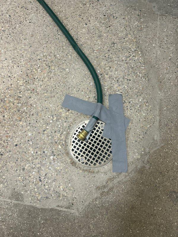 Performed camera inspection of residential plumbing system for newly installed shower stall with subway tile walls and terrazzo flooring. Documented drain system functionality and verified proper installation of central floor drain with chrome cover, as well as secondary floor drain location marked for future service work.