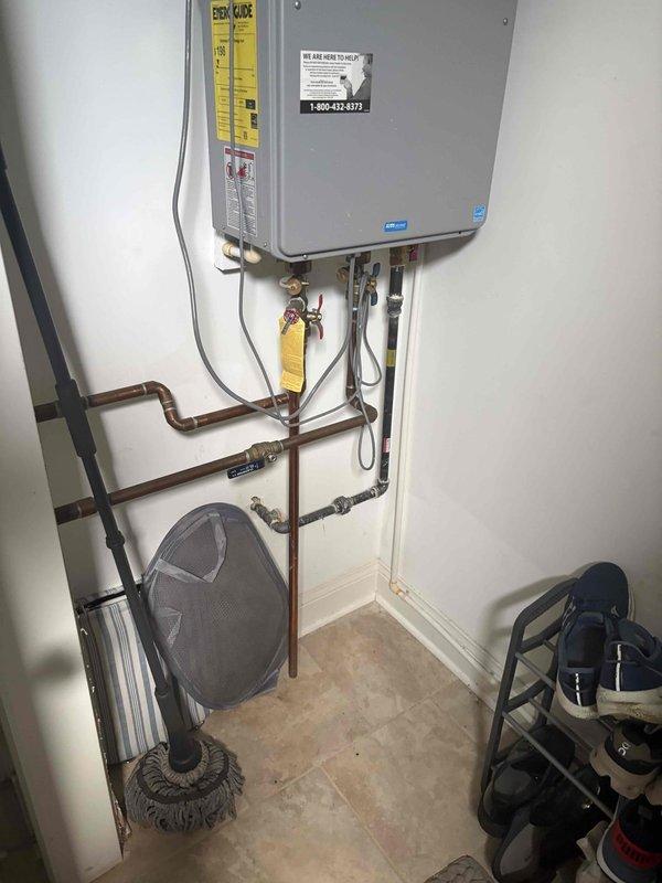 Responded to plumbing service call and performed diagnostic assessment of tankless water heater system. Identified required replacement parts and coordinated order through supply vendor. Documented existing installation configuration including copper supply lines, gas connections, and associated valving. System awaiting parts delivery to complete repair work.