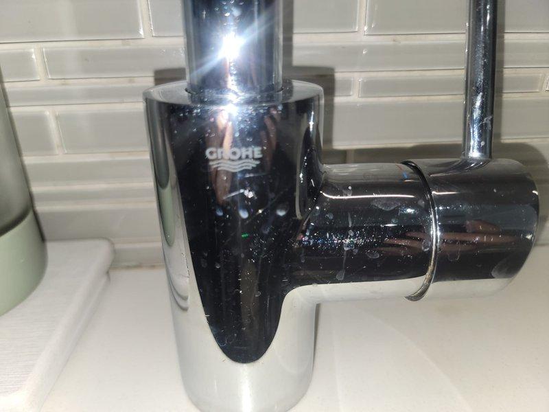 Responded to service call for leaking garbage disposal and kitchen faucet repair. Removed and replaced defective garbage disposal unit with new black disposal, securing mounting assembly to sink drain with proper flange connection. Connected discharge line to existing P-trap configuration using white PVC drainage pipes. Verified electrical connection and tested unit for proper operation and drainage. Inspected kitchen faucet and replaced worn cartridge to restore proper function and eliminate dripping. Tested all plumbing connections under sink for leaks, confirmed proper water flow, and verified garbage disposal grinding operation. All systems functioning correctly upon completion.