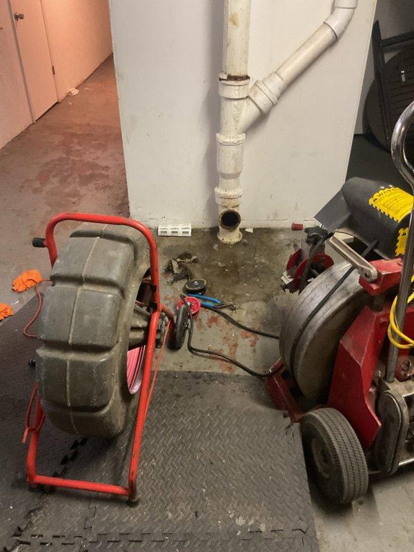 Responded to a mainline drain blockage and performed rodding service to clear the obstruction. Utilized professional drain cleaning equipment including motorized auger to snake and clear the main sewer line through the basement cleanout access point. Successfully restored proper drainage flow through the system.