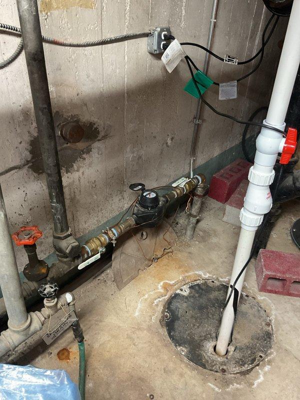 Completed installation of ADA-compliant toilet in residential bathroom with wall-mounted flush valve system and accessibility grab bars. All plumbing connections were secured and tested for proper function and leak-free operation.