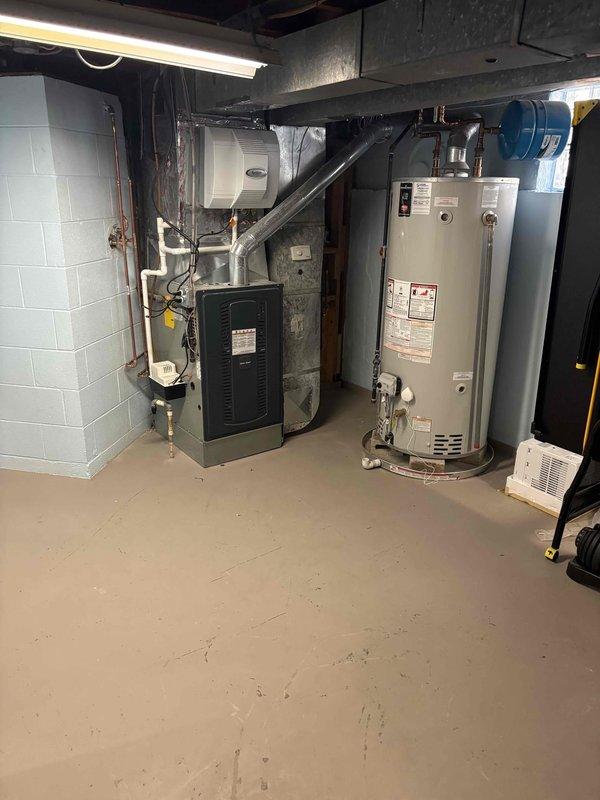 Completed follow-up service call to inspect plumbing installations in basement utility area and first-floor renovation space. Verified proper operation of water heater connections, copper piping runs, and PVC drain lines installed within exposed wall cavity during active remodeling project.