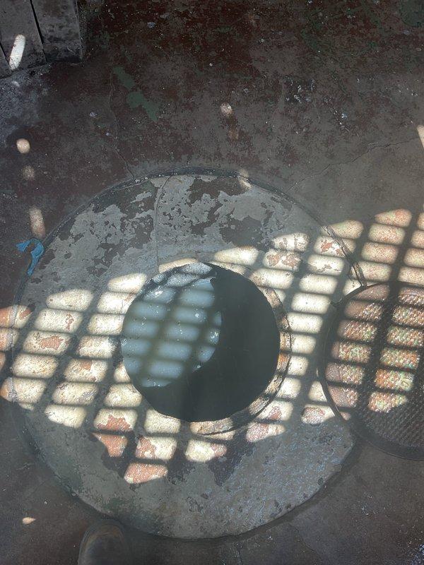Responded to an overflowing catch basin call and performed complete system assessment. Cleared the blockage causing the overflow condition, inspected the drainage system and associated plumbing connections, and verified proper flow restoration. Documented pre-existing conditions including stained concrete surfaces around the catch basin area and confirmed all PVC drainage pipes and connections were functioning correctly after service completion.