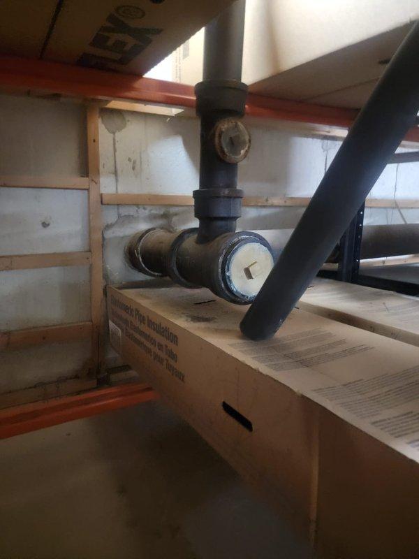 Responded to commercial property experiencing drainage backup in toilets and sinks during rain events. Inspected utility area plumbing system and main drainage lines to identify source of water intrusion causing fixture backups. Located and assessed floor-mounted mop sink, drainage infrastructure, and associated piping to determine blockage points and verify proper drainage flow throughout the system.