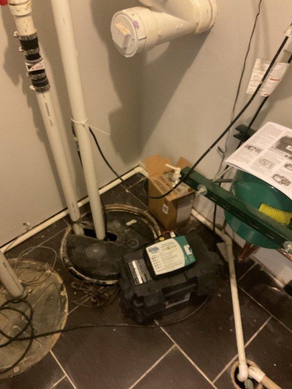 Performed comprehensive plumbing assessment of residential sump pump system and identified battery backup unit requiring replacement. Inspected existing pump installation with PVC discharge piping, ball valves, and electrical connections in utility room. Evaluated additional plumbing concerns including malfunctioning master bathroom tub faucet, non-operational jetted tub system, and defective shower head requiring repair or replacement.