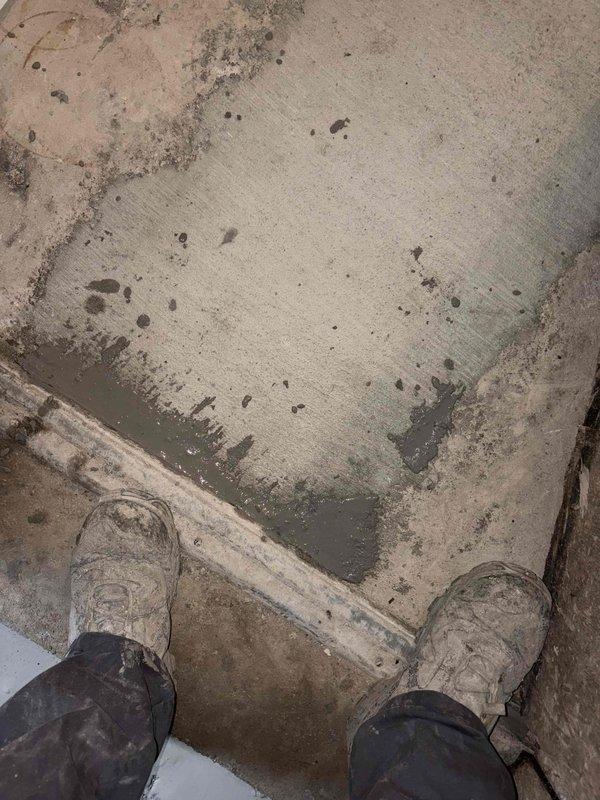 Performed concrete pour and leveling work for shower pan installation. Inspected and documented existing shower base condition, noting water drainage patterns and surface preparation requirements. Completed floor preparation work in adjacent workspace area, ensuring proper substrate conditions for plumbing fixture installation.