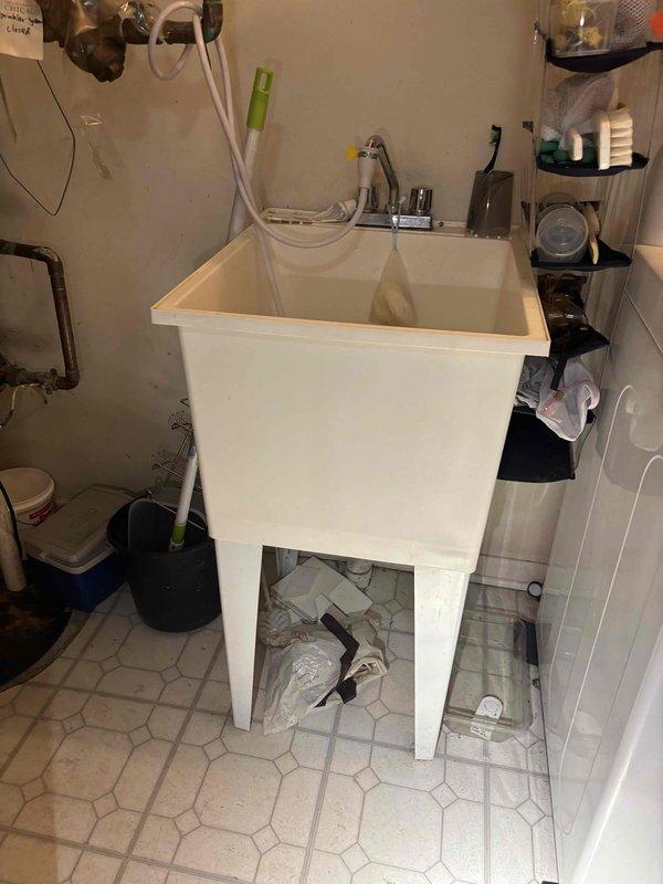 Conducted site assessment and documentation for two sink replacement projects. Photographed existing first-floor powder room pedestal sink and basement laundry utility sink to provide visual reference for product selection. Customer requested product specifications including brand, model numbers, and detailed information for white pedestal sink with optimal drainage characteristics and utility sink with integrated counter space before proceeding with installation work.