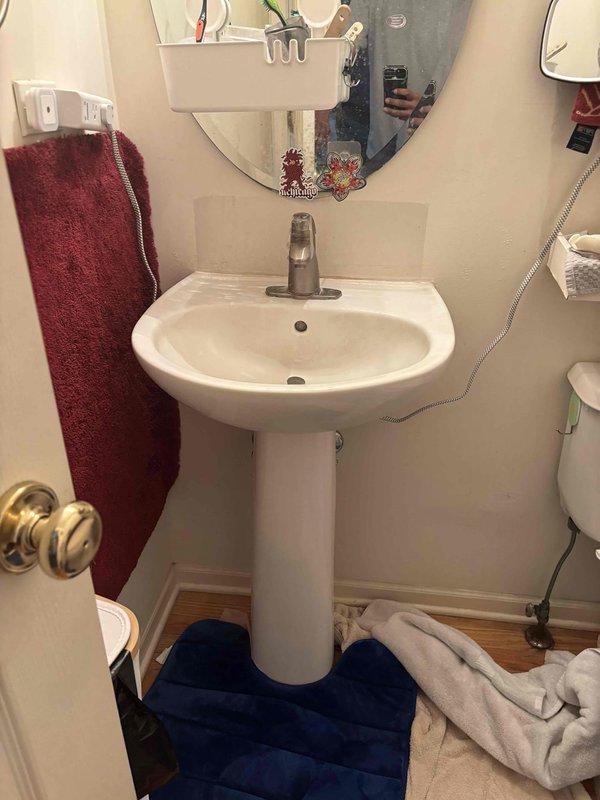 Conducted site assessment and documentation for two sink replacement projects. Photographed existing first-floor powder room pedestal sink and basement laundry utility sink to provide visual reference for product selection. Customer requested product specifications including brand, model numbers, and detailed information for white pedestal sink with optimal drainage characteristics and utility sink with integrated counter space before proceeding with installation work.