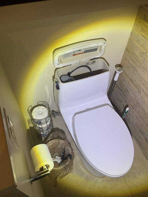Responded to service call for toilet producing hissing noise. Upon inspection, opened tank lid to diagnose the issue and identified the source of the continuous water flow sound. Examined the internal flush valve assembly, fill valve, and flapper mechanism on the modern one-piece toilet fixture equipped with electronic bidet seat. Performed necessary adjustments and repairs to eliminate the hissing noise and restore proper operation. Verified water supply line connections were secure and tested toilet functionality to ensure issue was fully resolved.