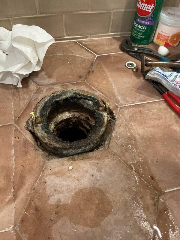 Replaced deteriorated wax ring seal on guest bathroom toilet after removing fixture and cleaning corroded flange area. Cleared slow-draining master bathroom shower using mechanical rodding equipment to restore proper drainage. Both fixtures tested and confirmed operational upon completion.