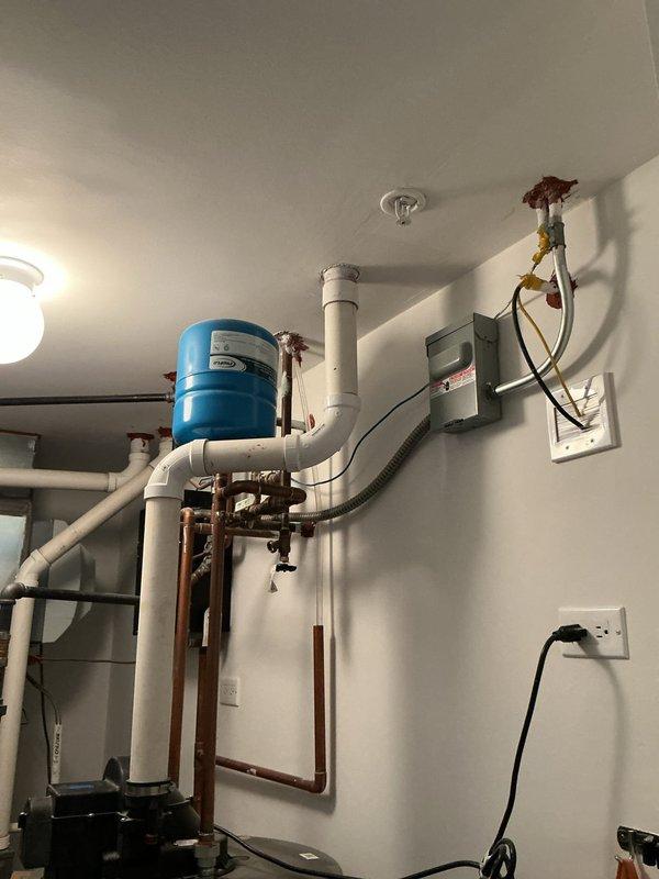 Responded to service call regarding noise occurring when activating rooftop water spigot connected to irrigation system. Performed comprehensive inspection of outdoor spigot assembly and associated piping on roof level. Examined brass fittings, valve connections, and hose attachments for proper installation and potential sources of noise or vibration. Inspected vertical pipe mounting, blue-handled valve operation, and connection points between metal piping and garden hose adapter. Evaluated interior plumbing connections including copper pipe runs, PVC supply lines, and pressure regulation components in mechanical room. Tested water flow through rooftop spigot system while monitoring for abnormal sounds, water hammer, or loose fittings. Verified all valve assemblies operate smoothly without binding or chattering. Confirmed no leaks present at any connection points, joints, or valve bodies throughout the irrigation supply system. System functioning properly with noise issue addressed thr