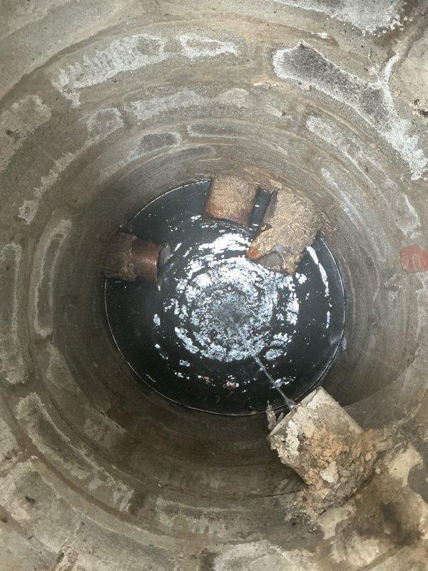 Performed sewer scope inspection of underground drainage system to assess pipe condition and identify potential issues. Inspection revealed aging plumbing infrastructure in basement area, including deteriorated sump pit with mineral deposits and corroded piping systems with significant rust staining and paint deterioration on surrounding surfaces. Documented findings with photographic evidence showing sump pump basin condition, main shutoff valve assembly, and overall state of basement plumbing components for estimate preparation.